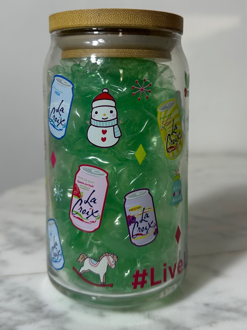 LaCroix Holiday Glass Jar with Green Decorative Fill and Festive Can Graphics
